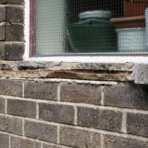 Uszkodzone parapety okien pod wpływem korozji belek wzmacniających